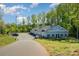 Well-maintained gray exterior of multi-office building with ample parking and lush landscaping at 19006 Brandon James Dr, Cornelius, NC 28031