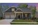Charming craftsman home with stone accents, a two-car garage, and a well-manicured front lawn at 19006 Brandon James Dr, Cornelius, NC 28031