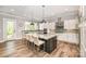Modern kitchen features a large island, breakfast bar, stainless steel appliances, and ample counter space at 19006 Brandon James Dr, Cornelius, NC 28031