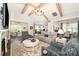 An expansive living room with fireplace, beamed ceiling, elegant furniture, and open floor plan at 19006 Brandon James Dr, Cornelius, NC 28031