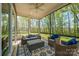 Relaxing screened porch with comfortable seating, ceiling fan, and scenic outdoor views at 19006 Brandon James Dr, Cornelius, NC 28031