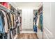 This walk-in closet features ample storage, shelving, and modern wood floors at 19006 Brandon James Dr, Cornelius, NC 28031