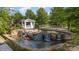 Charming water feature with a gazebo, waterfalls, and tranquil pond surrounded by landscaping at 19006 Brandon James Dr, Cornelius, NC 28031