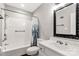 Bright bathroom featuring a tub with shower, white vanity and a decorative mirror at 194 Riverview Ter, Clover, SC 29710