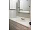 This bright bathroom features a white vanity with heart knobs and a decorative mirror at 194 Riverview Ter, Clover, SC 29710
