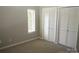 Carpeted bedroom featuring a window with blinds and double louvered door closets at 194 Riverview Ter, Clover, SC 29710