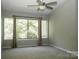 Spacious bedroom with neutral walls, large windows, and a contemporary ceiling fan at 194 Riverview Ter, Clover, SC 29710