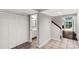 Hallway featuring a tiled floor that leads to the bathroom, stairs, and living room area at 194 Riverview Ter, Clover, SC 29710