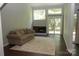 Cozy living room featuring a fireplace, large windows, a sliding glass door, and a comfortable sofa at 194 Riverview Ter, Clover, SC 29710