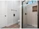Bathroom with glass shower door and tiled shower with corner storage and dark hardware at 2045 Cordia Cir, Newton, NC 28658