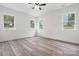 An empty bedroom space with three large windows and modern vinyl flooring at 2045 Cordia Cir, Newton, NC 28658