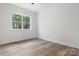 Bright bedroom with wood flooring and a large window overlooking a wooded area at 2045 Cordia Cir, Newton, NC 28658
