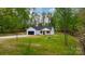 A charming home nestled on a lush, green lot with mature trees and a long driveway at 2045 Cordia Cir, Newton, NC 28658