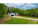 Beautifully landscaped home with white siding, black accents, a well-manicured lawn, and mature trees at 2045 Cordia Cir, Newton, NC 28658