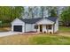 Beautifully designed house featuring a black garage door, inviting front porch, and well-manicured lawn at 2045 Cordia Cir, Newton, NC 28658