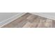 Close up of modern gray vinyl flooring and white base molding at 2045 Cordia Cir, Newton, NC 28658