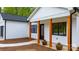 Beautiful white home features black-framed windows and a covered front porch with natural wood columns at 2045 Cordia Cir, Newton, NC 28658
