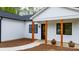 Beautiful white home features black-framed windows and a covered front porch with natural wood columns at 2045 Cordia Cir, Newton, NC 28658