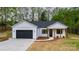 Home featuring white siding, black accents, a long driveway, and a meticulously landscaped yard at 2045 Cordia Cir, Newton, NC 28658