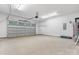 Spacious garage with an insulated door, side door, overhead lighting, and sealed concrete flooring at 2045 Cordia Cir, Newton, NC 28658