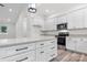 A modern kitchen with white cabinets, a stainless steel oven, and an island with light countertop at 2045 Cordia Cir, Newton, NC 28658