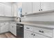 Bright kitchen with stainless steel dishwasher, light countertops, and white cabinets with dark hardware at 2045 Cordia Cir, Newton, NC 28658