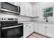 A modern kitchen featuring light countertops, stainless steel appliances and all white cabinets at 2045 Cordia Cir, Newton, NC 28658