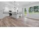Modern all-white kitchen with stainless steel appliances, kitchen island, and luxury vinyl plank flooring at 2045 Cordia Cir, Newton, NC 28658