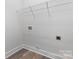 The laundry room has wood flooring and a wire rack for storage at 2045 Cordia Cir, Newton, NC 28658