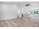 Bright open living space featuring vaulted ceilings, modern ceiling fan, and kitchen in the background at 2045 Cordia Cir, Newton, NC 28658