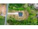 Aerial view of the home with a green line showing property lines surrounded by mature trees in a private setting at 2045 Cordia Cir, Newton, NC 28658