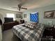 Bedroom featuring a double bed with a blue and white plaid comforter and a ceiling fan at 22 Heritage View Rd, Hickory, NC 28601