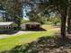 House exterior with well manicured lawn, covered parking, and basketball court at 22 Heritage View Rd, Hickory, NC 28601