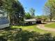 Home exterior featuring a well-maintained lawn and a basketball court at 22 Heritage View Rd, Hickory, NC 28601