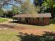 Charming single-story brick home with a welcoming front yard featuring a tree swing at 22 Heritage View Rd, Hickory, NC 28601