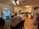 Functional kitchen and dining area with white cabinetry, wood floors, and ample counter space at 22 Heritage View Rd, Hickory, NC 28601