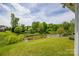 Backyard featuring a green lawn, mature trees and a waterway at 269 Tradition Way, Rock Hill, SC 29732