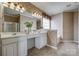 Bathroom featuring double sinks, decorative wallpaper, and a large mirror at 269 Tradition Way, Rock Hill, SC 29732