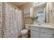 Bathroom featuring a white sink, cabinet, toilet, and shower with colorful curtain at 269 Tradition Way, Rock Hill, SC 29732