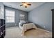 Cozy bedroom with blue walls, a ceiling fan, and a large window at 269 Tradition Way, Rock Hill, SC 29732