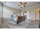 Neutral bedroom features a ceiling fan and an ensuite bathroom at 269 Tradition Way, Rock Hill, SC 29732