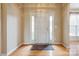 Bright foyer with hardwood floors, white door, sidelights, and transom window at 269 Tradition Way, Rock Hill, SC 29732