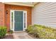 Inviting entryway with a green door, sidelights, and landscaped garden beds at 269 Tradition Way, Rock Hill, SC 29732