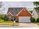 Charming single-story brick home with a manicured lawn and a two-car garage at 269 Tradition Way, Rock Hill, SC 29732