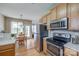 Modern kitchen with stainless steel appliances, wood cabinets, and tile backsplash at 269 Tradition Way, Rock Hill, SC 29732
