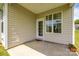Covered patio with neutral siding, a small window, and door leading outside at 269 Tradition Way, Rock Hill, SC 29732
