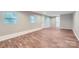 Expansive basement area with a walkout entrance and wood-look flooring, ready for customization and expansion at 2924 Parkway Ave, Charlotte, NC 28208