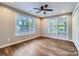 Sunlit bedroom with ample windows, ceiling fan and wood-look floors, creating a cozy atmosphere at 2924 Parkway Ave, Charlotte, NC 28208