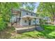 Two-story home featuring a spacious patio with dual staircases, surrounded by mature trees, and offering a serene outdoor living space at 2924 Parkway Ave, Charlotte, NC 28208