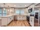 Well-lit kitchen showcases stainless steel appliances, white subway tile backsplash and white cabinets at 2924 Parkway Ave, Charlotte, NC 28208